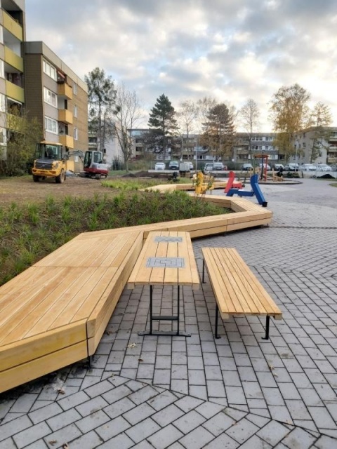 euroform w - street furniture - long angled bench made of wood on city square - designer bench made of wood for outside - wooden seating island for urban space - Isola high quality street furniture