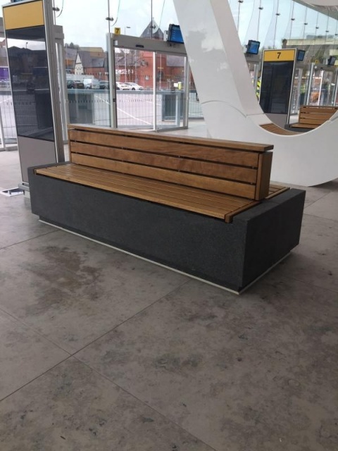 euroform w - sustainable urban furniture - organic, minimalist bench at train station - curved bench for outdoors - modular bench - seating island - sustainable seating furniture
