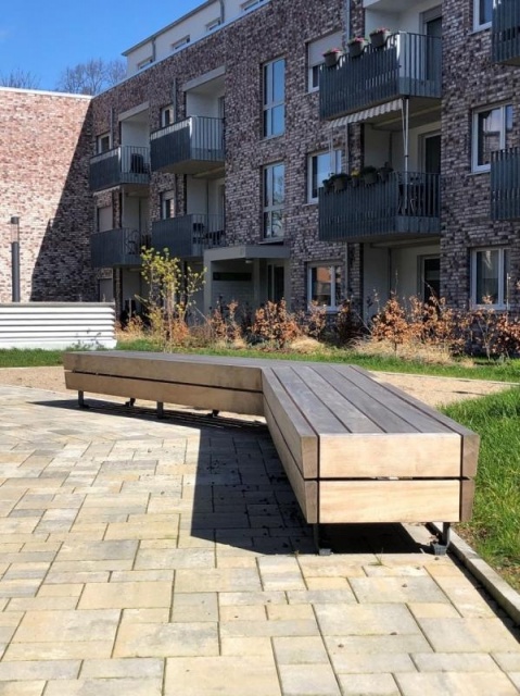 euroform w - street furniture - Bench Isola made of wood in courtyard in Germany - minimalist bench for public space - wooden park bench for outdoors