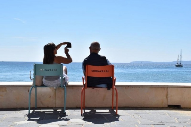 euroform w - street furniture - people sitting at sturdy stool made of high-quality metal steel at promenade of Le Lavandou at Cote d