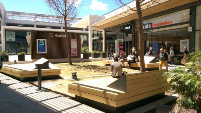 euroform w - street furniture - huge bench made of wood in shopping centre in France - designer bench made of wood for outside - wooden seating island for urban space - high quality street furniture