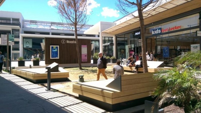 euroform w - street furniture - huge bench made of wood in shopping centre in France - designer bench made of wood for outside - wooden seating island for urban space - high quality street furniture