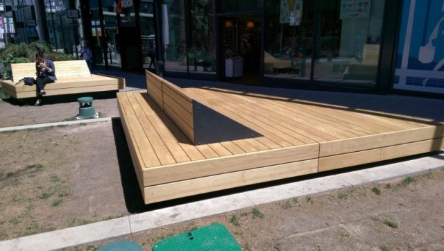 euroform w - street furniture - huge bench made of wood in shopping centre in France - designer bench made of wood for outside - wooden seating island for urban space - high quality street furniture