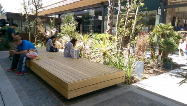 euroform w - street furniture - huge bench made of wood in shopping centre in France - designer bench made of wood for outside - wooden seating island for urban space - high quality street furniture