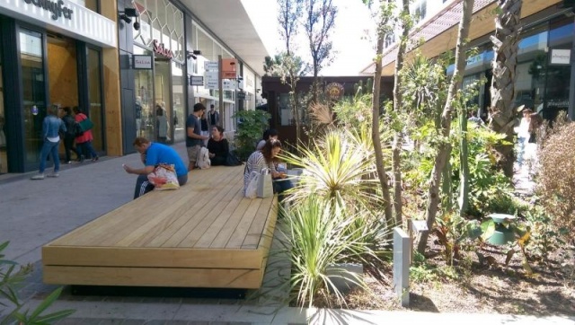 euroform w - street furniture - huge bench made of wood in shopping centre in France - designer bench made of wood for outside - wooden seating island for urban space - high quality street furniture