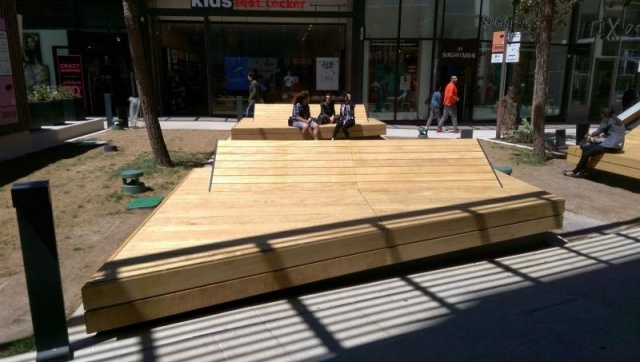 euroform w - street furniture - huge bench made of wood in shopping centre in France - designer bench made of wood for outside - wooden seating island for urban space - high quality street furniture