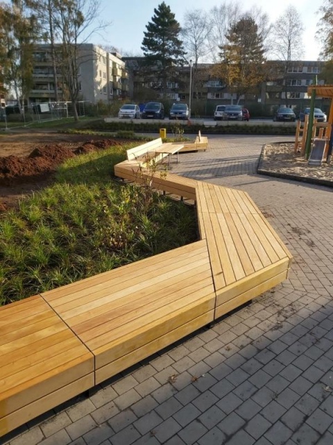 euroform w - street furniture - long angled bench made of wood on city square - designer bench made of wood for outside - wooden seating island for urban space - Isola high quality street furniture