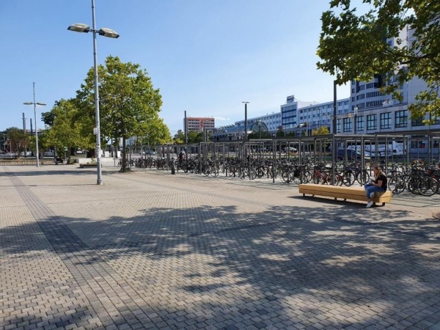 euroform w - street furniture - long angled bench made of wood on city square - designer bench made of wood for outside - wooden seating island for urban space - Isola high quality street furniture