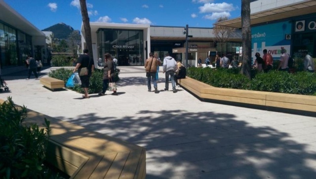 euroform w - street furniture - long angled bench made of wood on city square - designer bench made of wood for outside - wooden seating island for urban space - Isola high quality street furniture