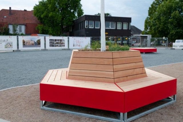 euroform w - street furniture - angular bench made of wood and coloured metal on a public square in Weyhe - seating island for public spaces - bespoke street furniture for Weyhe Germany - Bench planter with tree in the middle