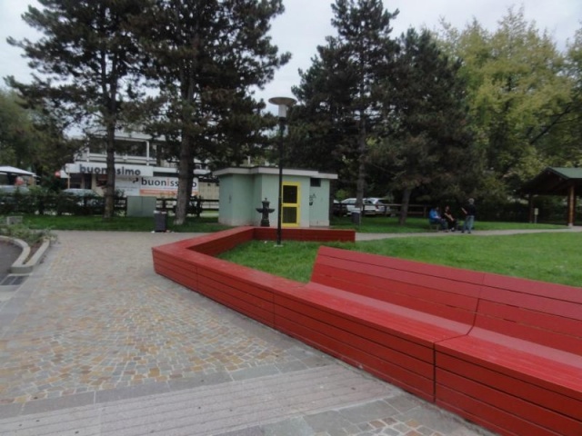 euroform w - urban furniture - customized wooden red bench at city centre in Rovereto - wooden seating at public place - customized street furniture